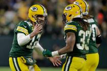 Green Bay Packers' Aaron Rodgers celebrates an Aaron Jones' touchdown run during the second hal ...