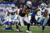 Raiders tight end Darren Waller (83) makes a big catch and run past Dallas Cowboys safety Jayro ...