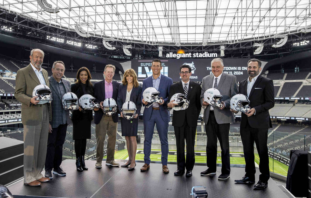 VIP guests hold ceremonial helmets on stage following a press conference event announcing the N ...