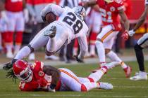 Kansas City Chiefs outside linebacker Nick Bolton (54) takes out the feet of Raiders running ba ...