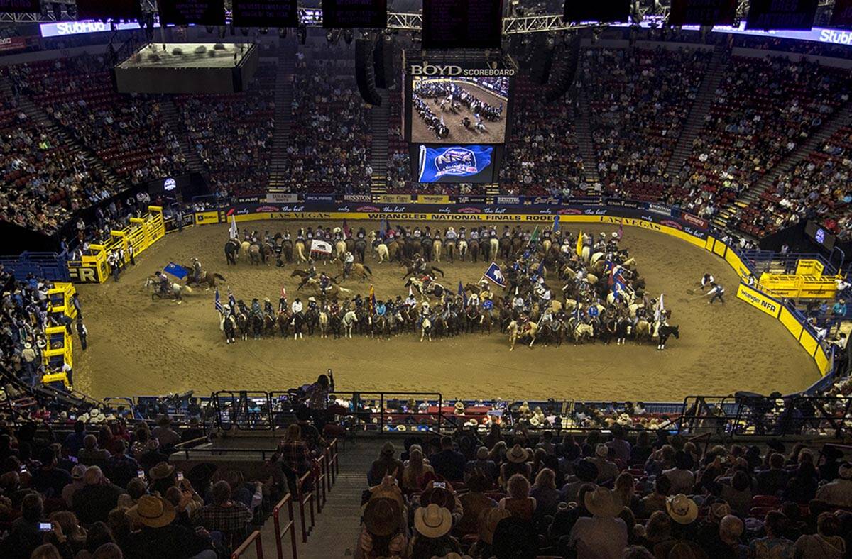 Competitors gather in the arena as the fans applaud at the start of the opening night of Wrangl ...