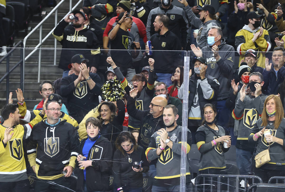 Golden Knights fans celebrate after a goal by defenseman Zach Whitecloud, not pictured, during ...