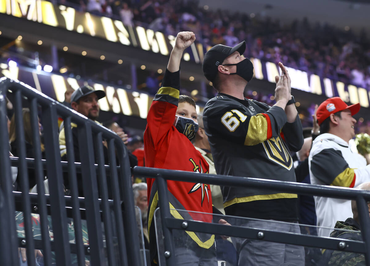 Golden Knights fans celebrate after a goal by defenseman Zach Whitecloud, not pictured, during ...
