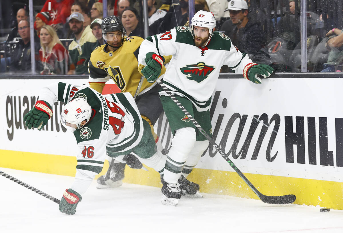 Minnesota Wild defenseman Jared Spurgeon (46) gets tripped up as Minnesota Wild defenseman Alex ...