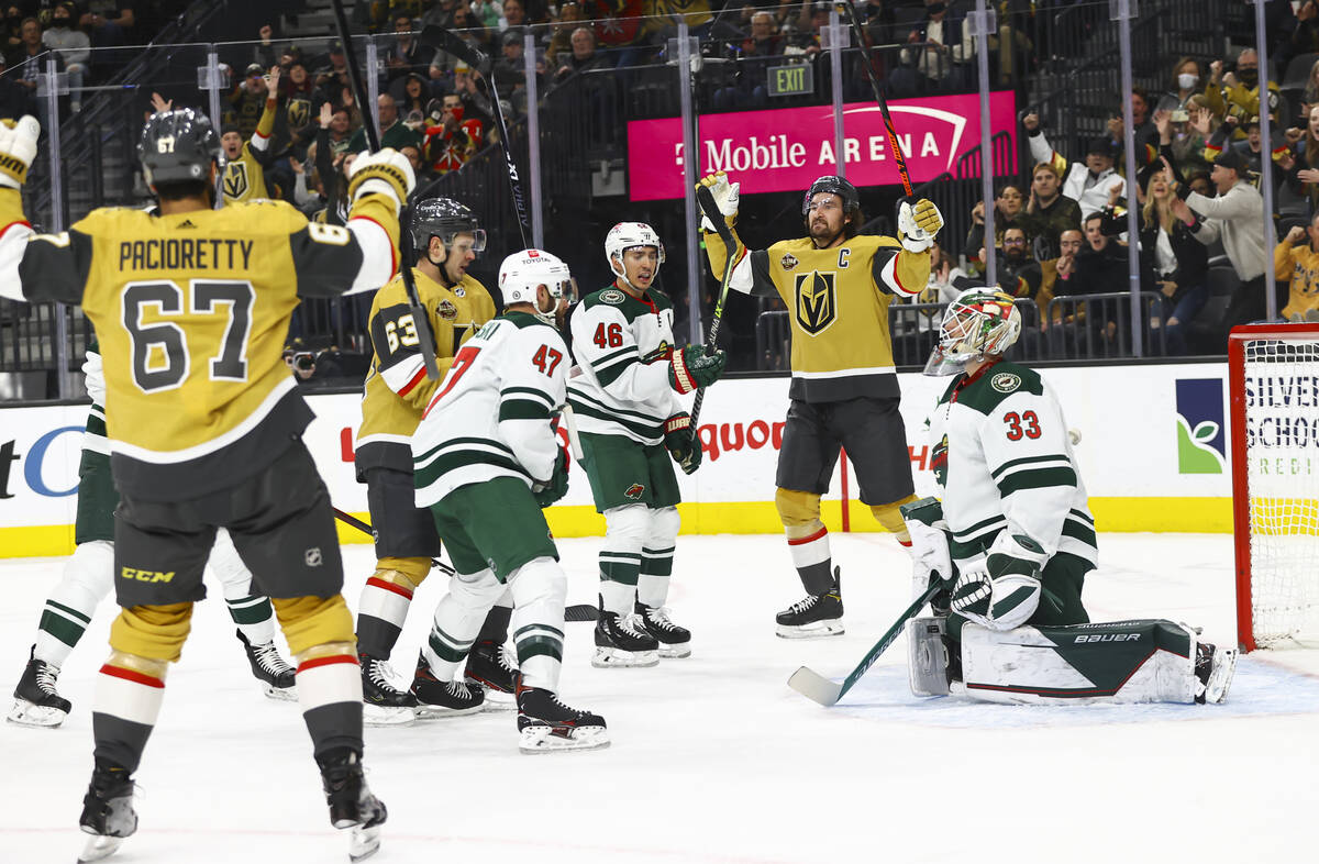 Golden Knights right wing Evgenii Dadonov (63) scores a goal past Minnesota Wild goaltender Cam ...