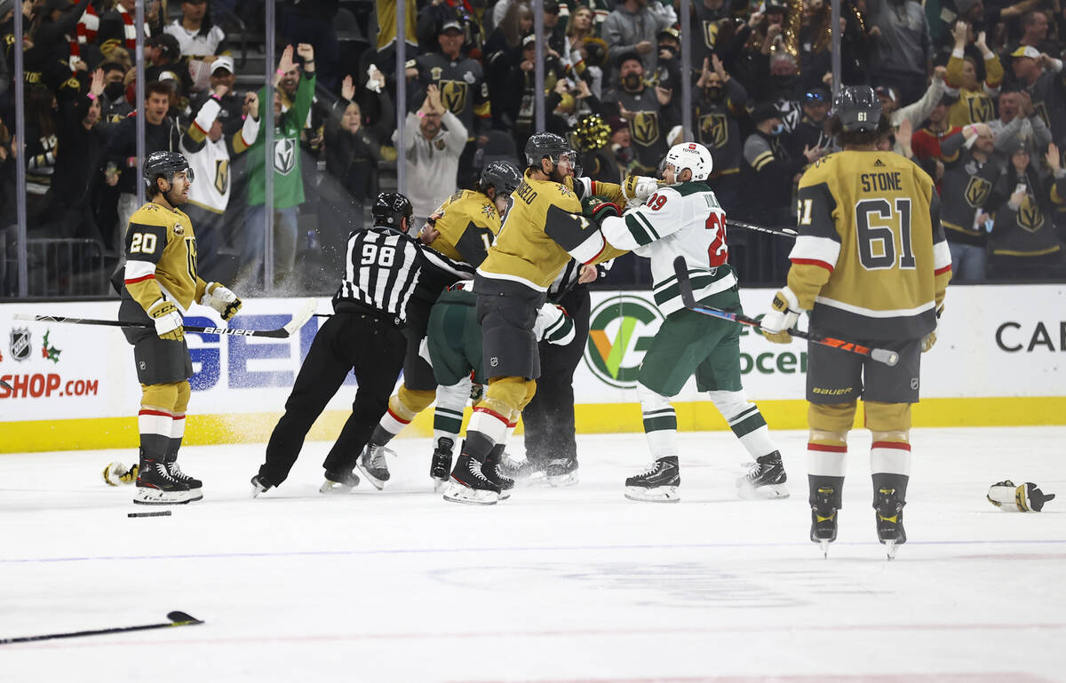 Members of the Golden Knights and Minnesota Wild fight during the second period of an NHL hocke ...