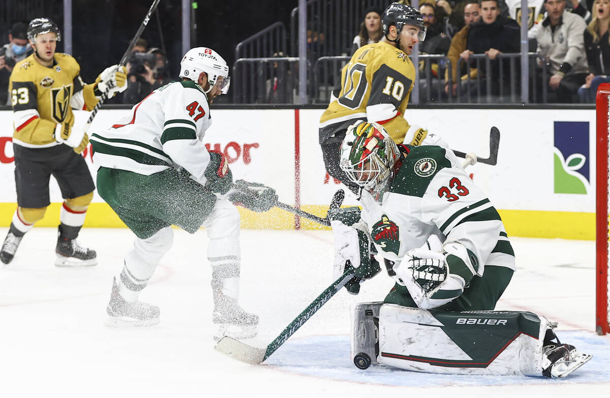 Minnesota Wild goaltender Cam Talbot (33) looks to stop the puck during the third period of an ...