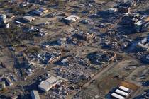 In this aerial photo, a collapsed factory and surrounding areas are seen in Mayfield, Ky., Sund ...