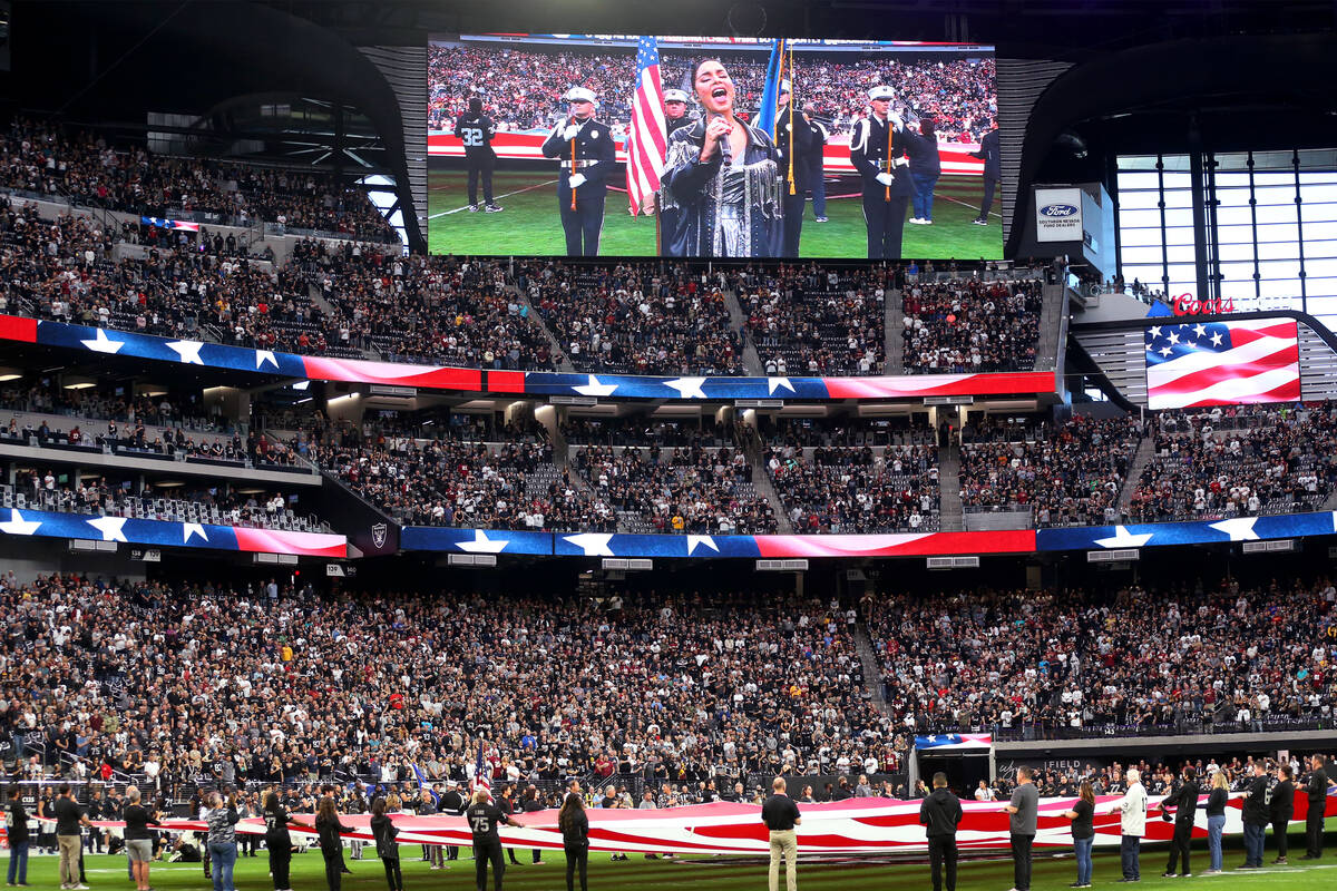 Vanessa Hudgens sings the National Anthem before the start of an NFL football game between the ...