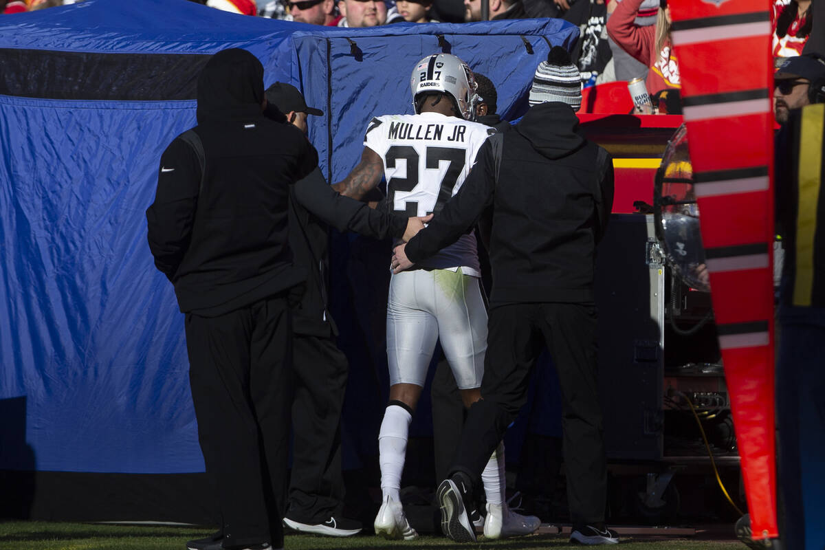 Raiders cornerback Trayvon Mullen (27) is helped off the field into the tent to be assessed for ...