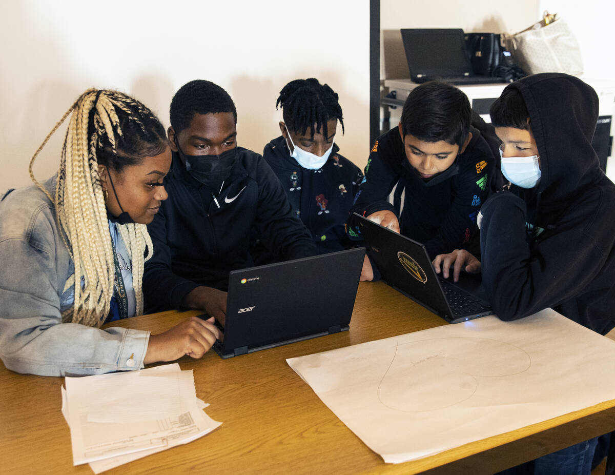 Chantel Brown, a substitute teacher at Bailey Middle School, works with students at the school& ...