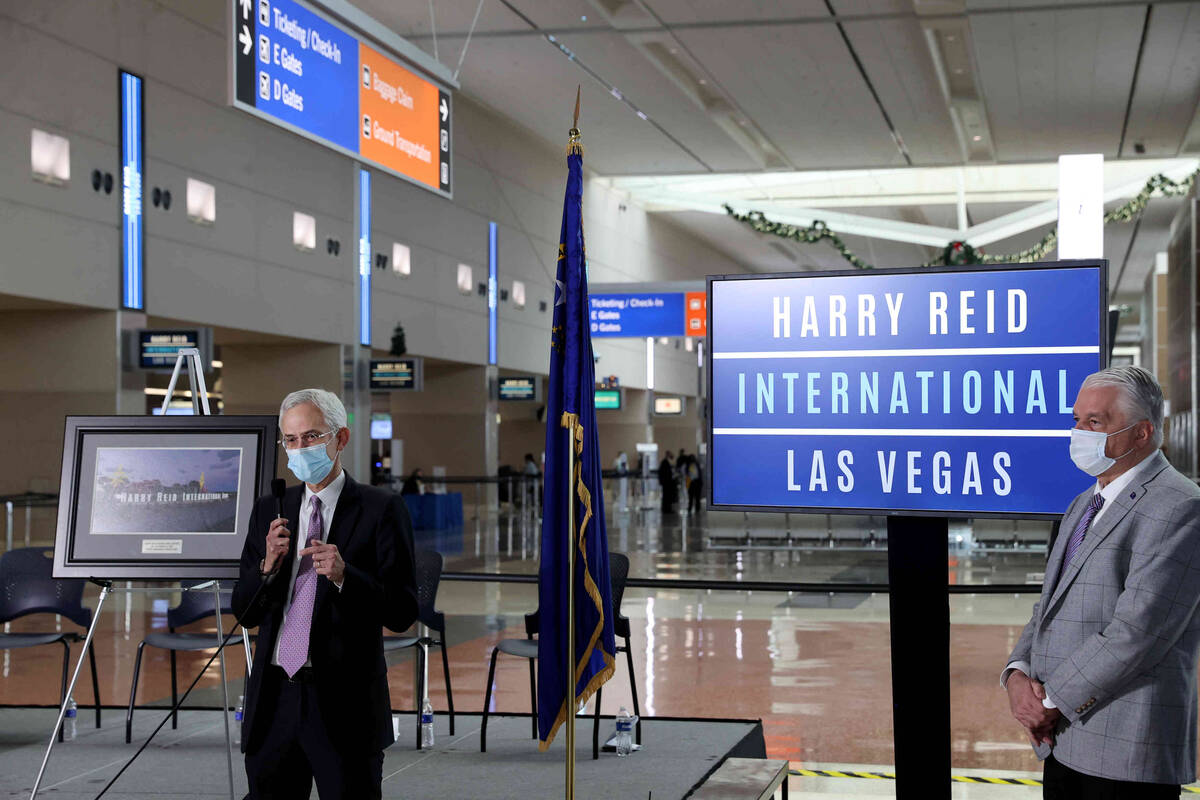 Rory Reid, son of Harry Reid, left, speaks as Nevada Gov. Steve Sisolak looks on during a cerem ...