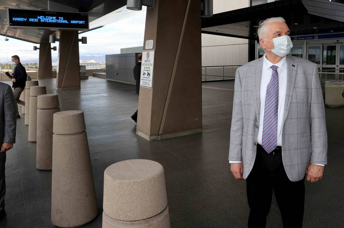 Nevada Gov. Steve Sisolak checks out new branding for Harry Reid international Airport after a ...