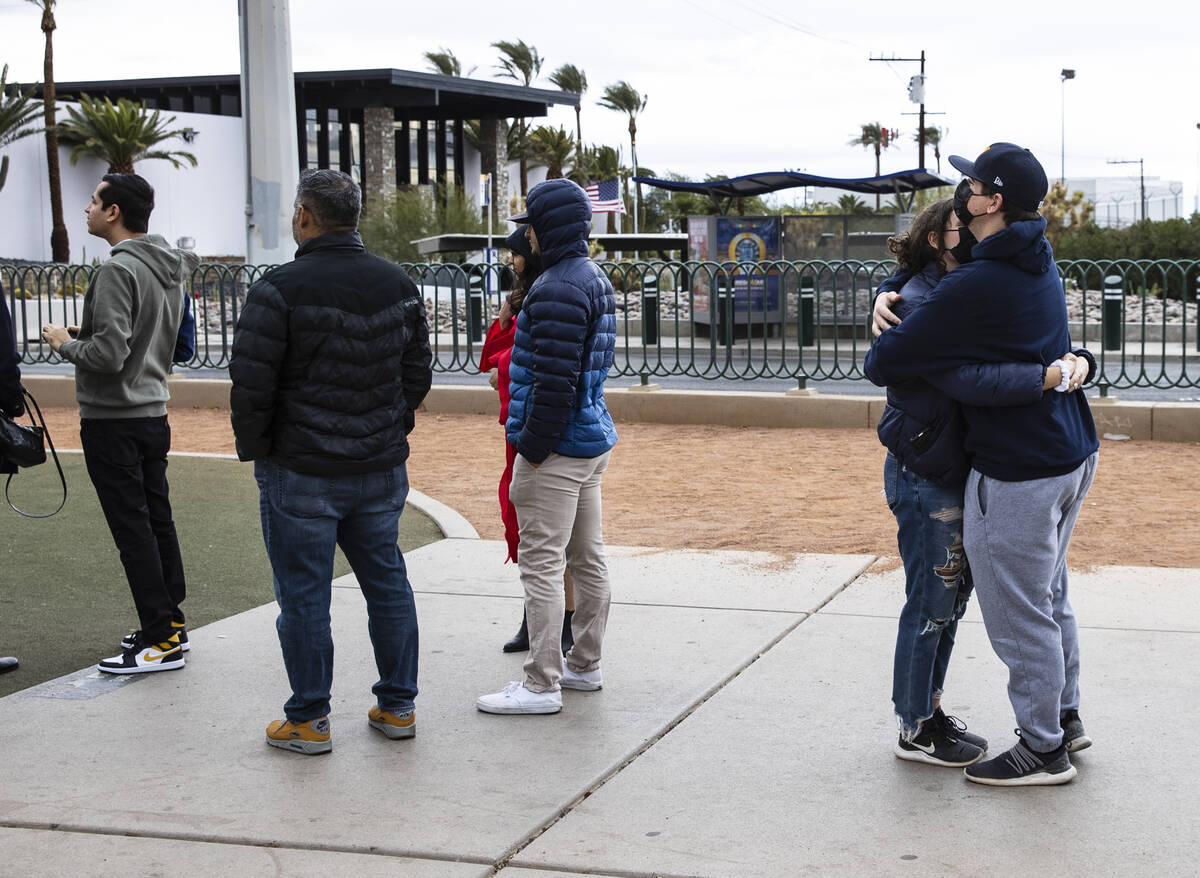 Emerson Arnold of Las Vegas hugs as he tries to protect his girlfriend Michela Michielli of Cap ...