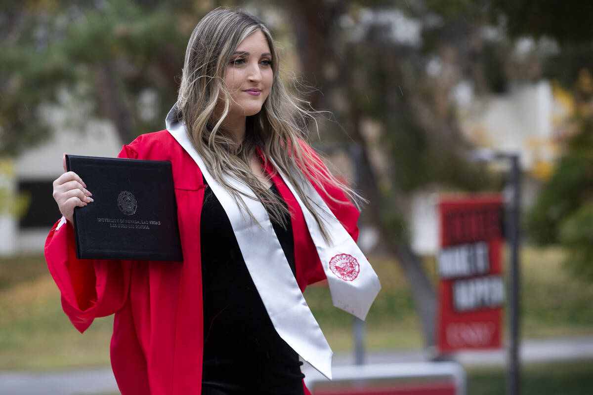 Ashley Seidel, a graduate from the UNLV Lee Business School, poses for photos during windy weat ...