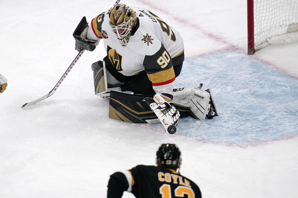 Vegas Golden Knights goaltender Robin Lehner (90) makes a save on a shot by Boston Bruins cente ...