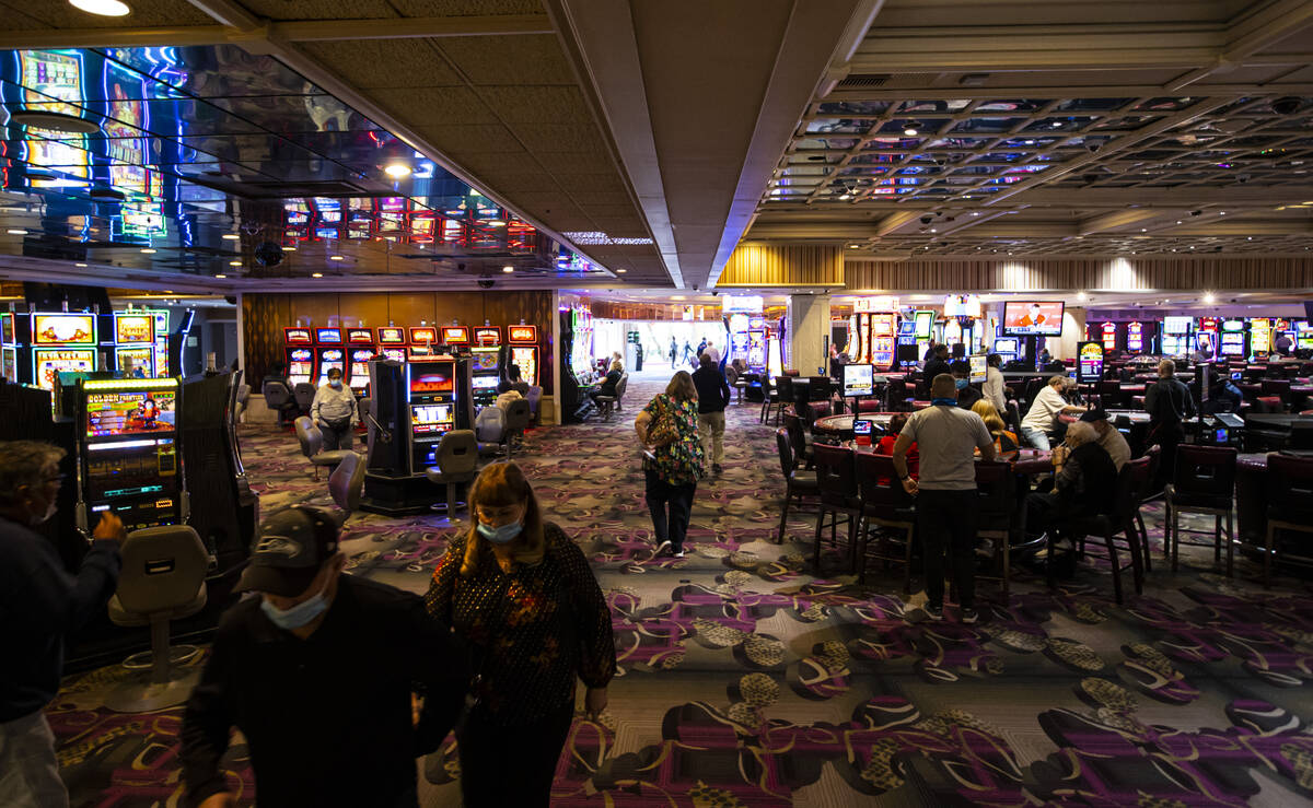 People walk the casino floor at the Flamingo in Las Vegas on Wednesday, Dec. 8, 2021. (Chase St ...