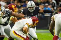Raiders defensive end Malcolm Koonce (51) gets a hand on Washington Football Team quarterback T ...