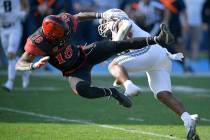 San Diego State Aztecs safety Trenton Thompson (18) and Utah State running back Calvin Tyler (4 ...
