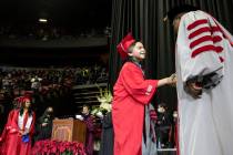 Jack Rico, a 15-year-old college graduate, shakes UNLV President Keith Whitfield's hand as he a ...