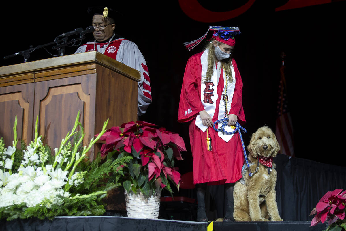 UNLV hospitality graduate Katie Derr is honored by President Keith Whitfield as an outstanding ...
