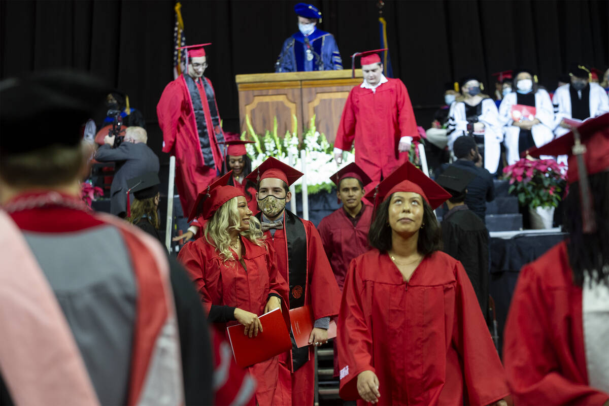 UNLV education graduates exit the stage after accepting their diplomas during commencement at t ...