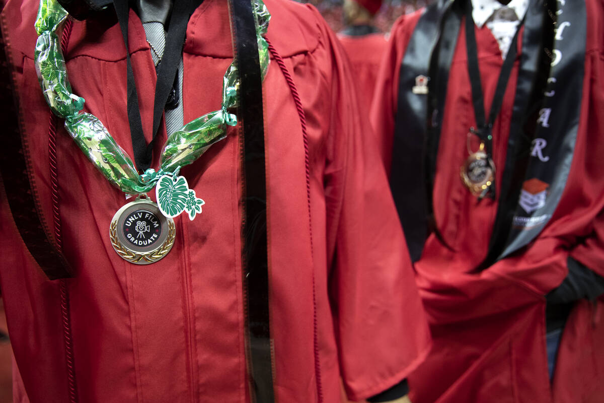 UNLV fine arts graduates wear film with their gowns during commencement at the Thomas & Mac ...