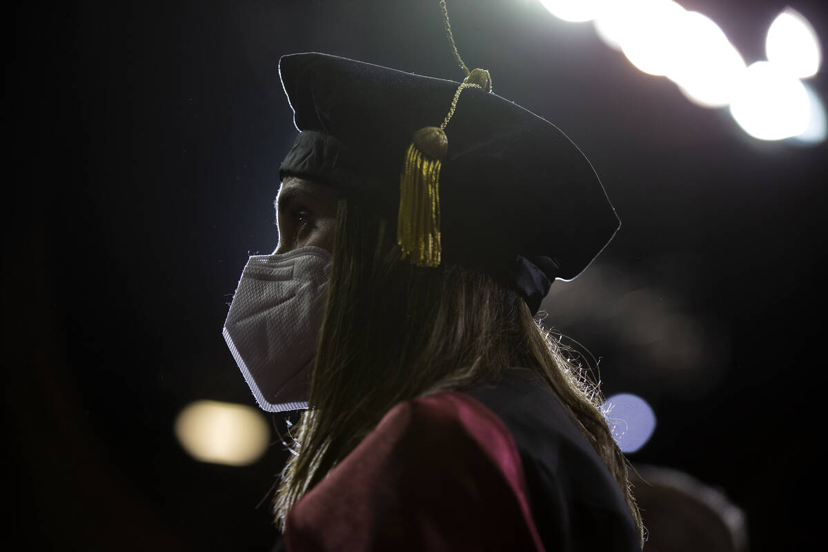 One UNLV graduate wears a mask to prevent the spread of COVID-19 during commencement at the Tho ...