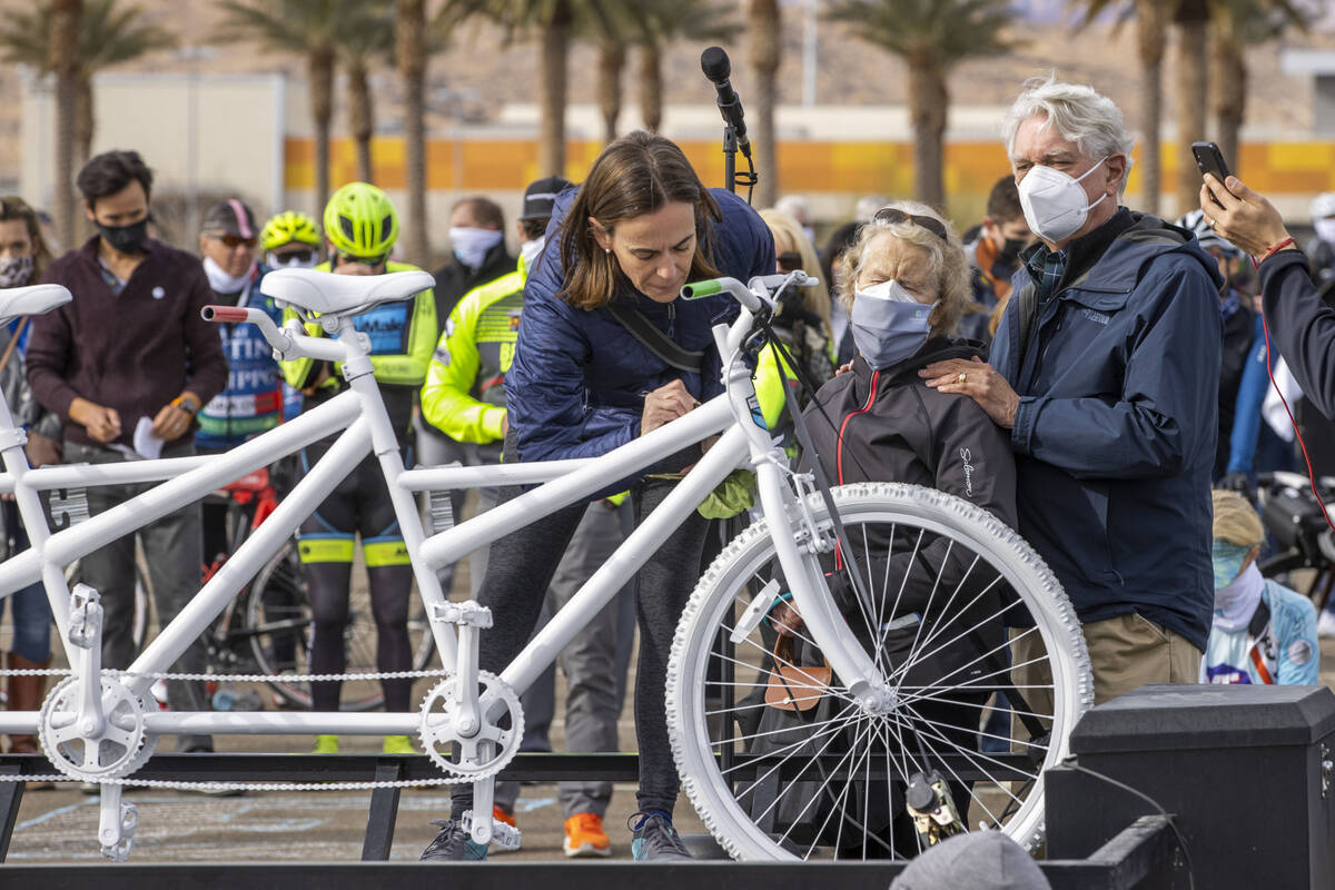 Donna Trauger, left, signs a bike for her late husband Tom Trauger as Tom's parents Susan and J ...