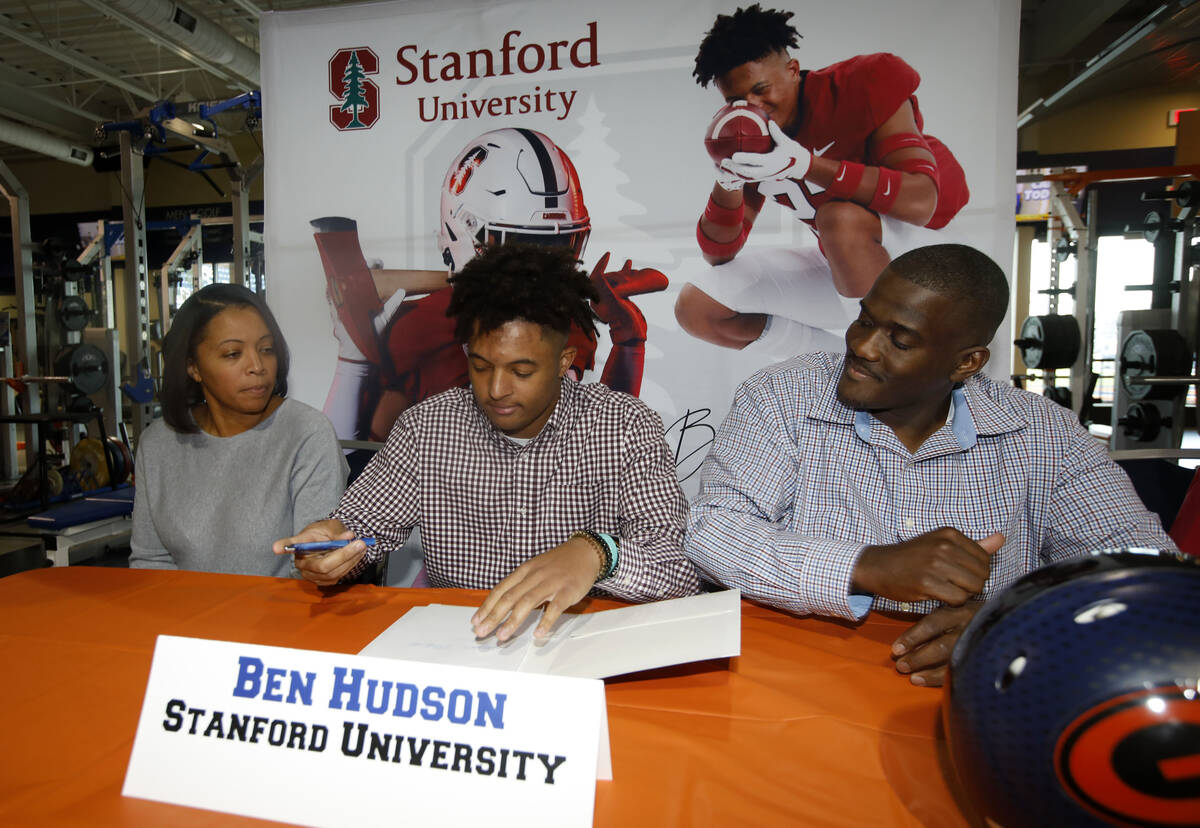 Bishop Gorman High School football player Benjamin Hudson, center, signs with Stanford Universi ...