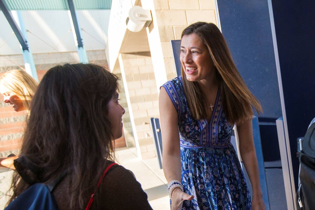 Principal Lisa Burkhead greets students as they arrive for the first day of classes at Foothill ...