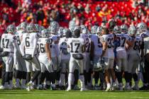 The Raiders huddle over the Kansas City Chiefs logo before an NFL football game on Sunday, Dec. ...