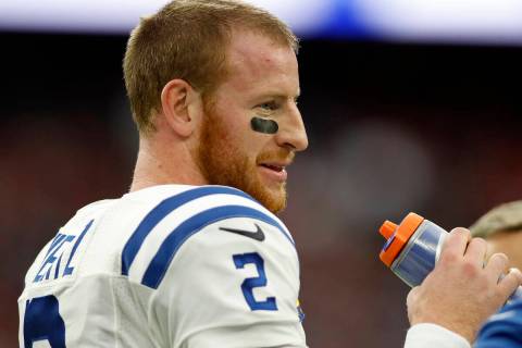 Indianapolis Colts backmost   Carson Wentz (2) waits for play   to resume during an NFL shot   ...