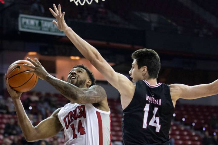 UNLV Rebels forward Royce Hamm Jr. (14) drives past Omaha Mavericks center Dylan Brougham (14) ...
