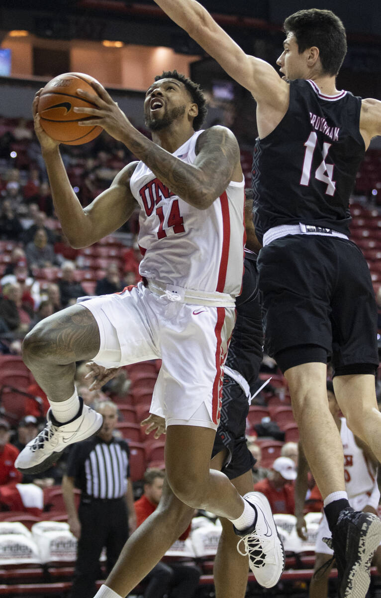 UNLV Rebels forward Royce Hamm Jr. (14) drives past Omaha Mavericks center Dylan Brougham (14) ...