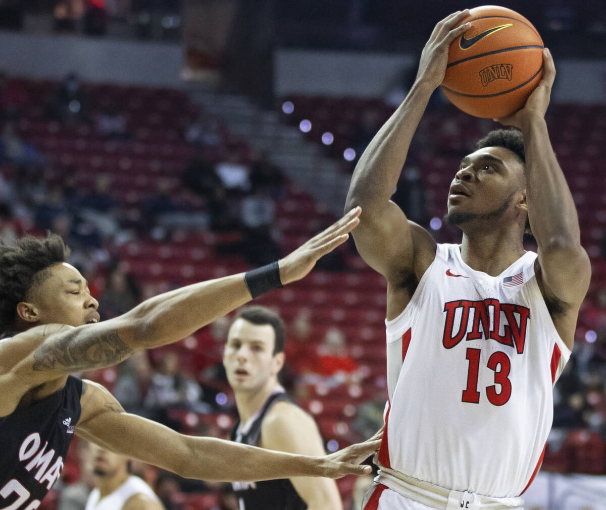 UNLV Rebels guard Bryce Hamilton (13) shoots over an Omaha Mavericks defender in the first half ...