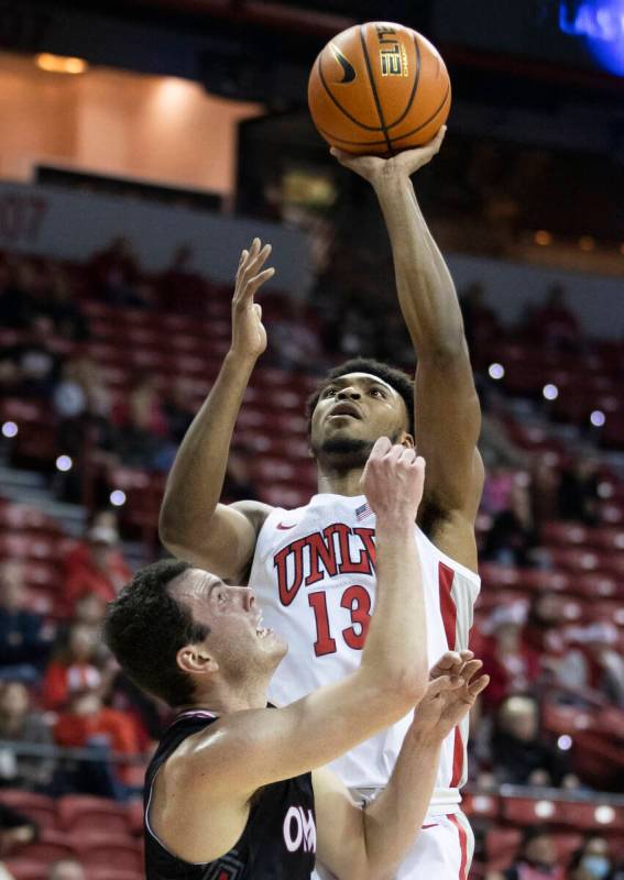 UNLV Rebels guard Bryce Hamilton (13) shoots over Omaha Mavericks center Dylan Brougham (14) in ...