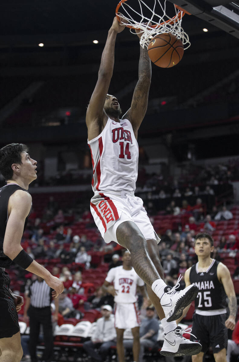 UNLV Rebels forward Royce Hamm Jr. (14) dunks over Omaha Mavericks center Dylan Brougham (14) a ...