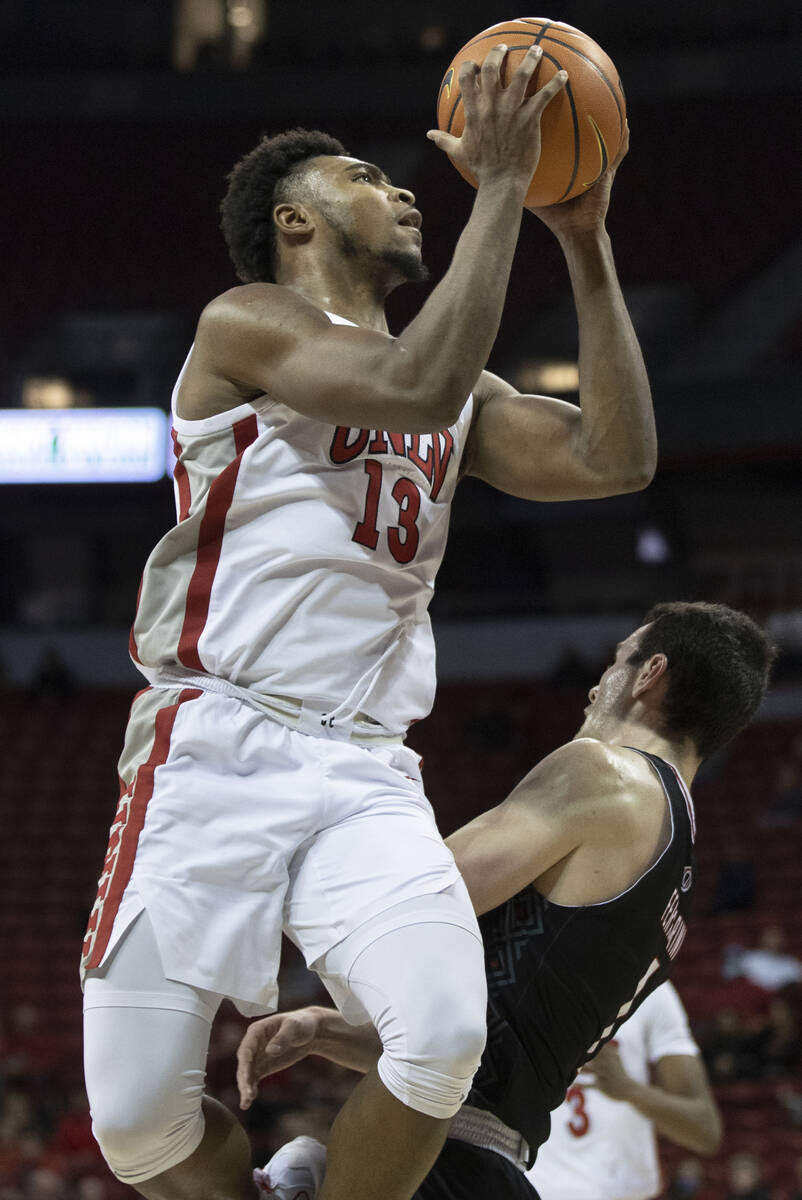 UNLV Rebels forward Royce Hamm Jr. (14) spins around Omaha Mavericks guard Nick Ferrarini (1) i ...