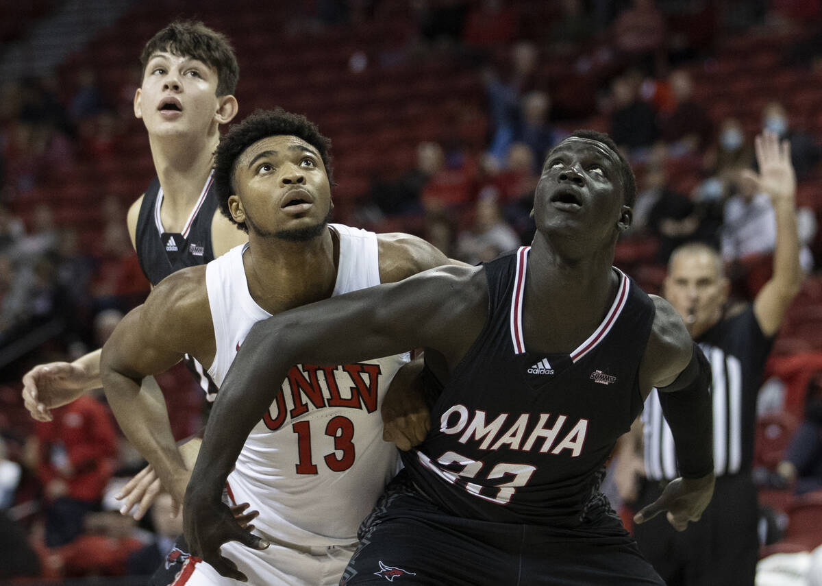 UNLV Rebels guard Bryce Hamilton (13) fights for a rebound with Omaha Mavericks forward Akol Ar ...