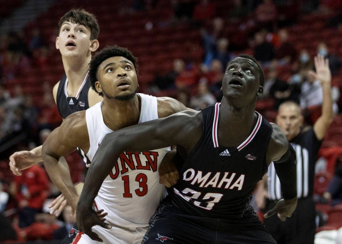 UNLV Rebels guard Bryce Hamilton (13) fights for a rebound with Omaha Mavericks forward Akol Ar ...