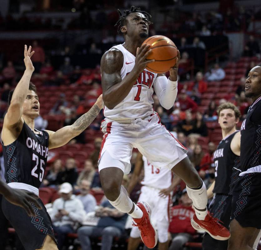 UNLV Rebels guard Michael Nuga (1) gets fouled while driving past Omaha Mavericks guard Felix L ...