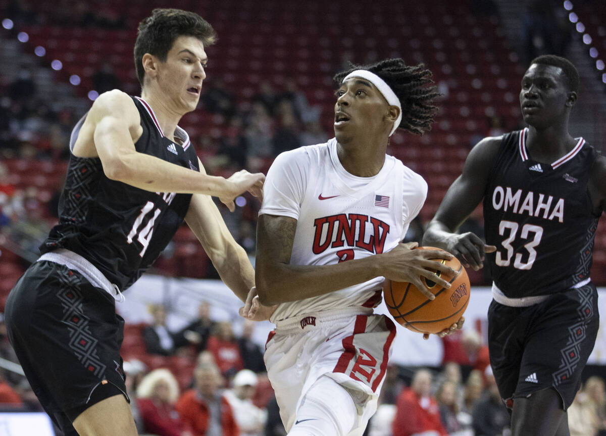 UNLV Rebels forward Donovan Williams (3) drives past Omaha Mavericks center Dylan Brougham (14) ...