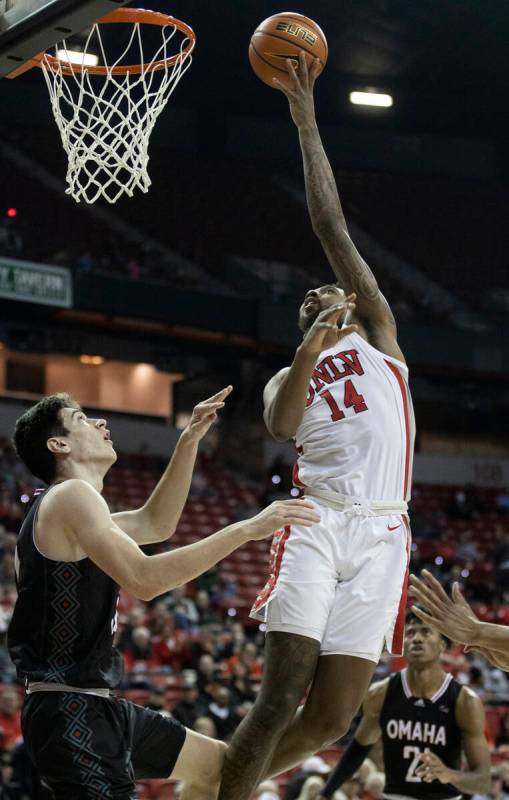 UNLV Rebels forward Royce Hamm Jr. (14) shoots over Omaha Mavericks center Dylan Brougham (14) ...