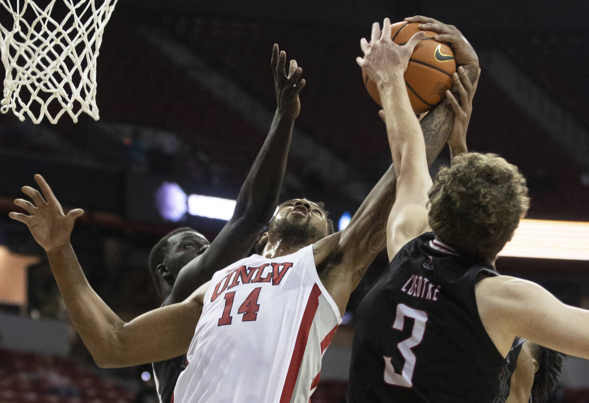 UNLV Rebels forward Royce Hamm Jr. (14) fights for a rebound with Omaha Mavericks guard Romain ...