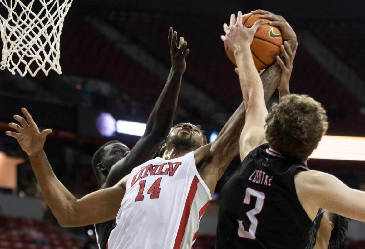 UNLV Rebels forward Royce Hamm Jr. (14) fights for a rebound with Omaha Mavericks guard Romain ...