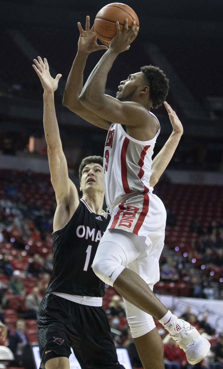 UNLV Rebels guard Bryce Hamilton (13) shoots over Omaha Mavericks forward Wanjang Tut (13) in t ...