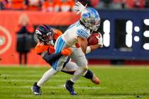 Detroit Lions wide receiver Kalif Raymond (11) is tackled by Denver Broncos safety Caden Sterns ...