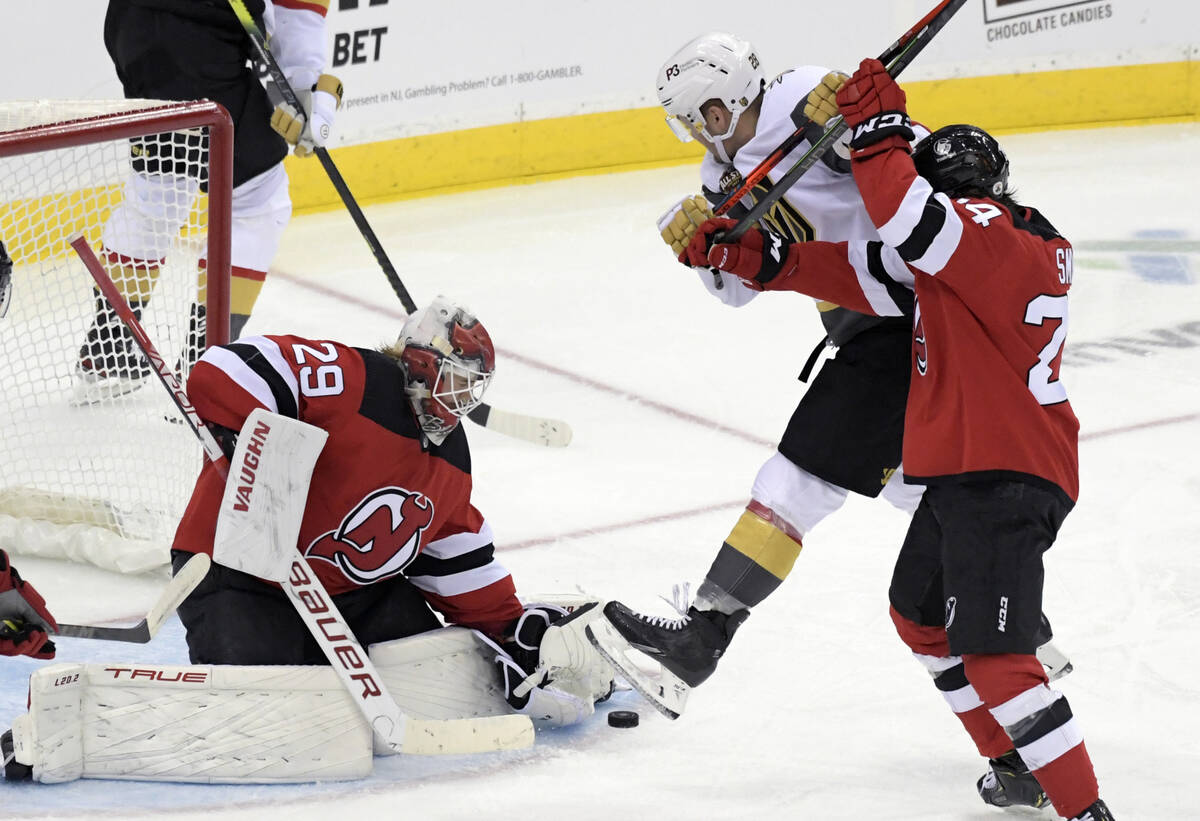 New Jersey Devils goaltender Mackenzie Blackwood (29) stops the puck as Devils defenseman Ty Sm ...