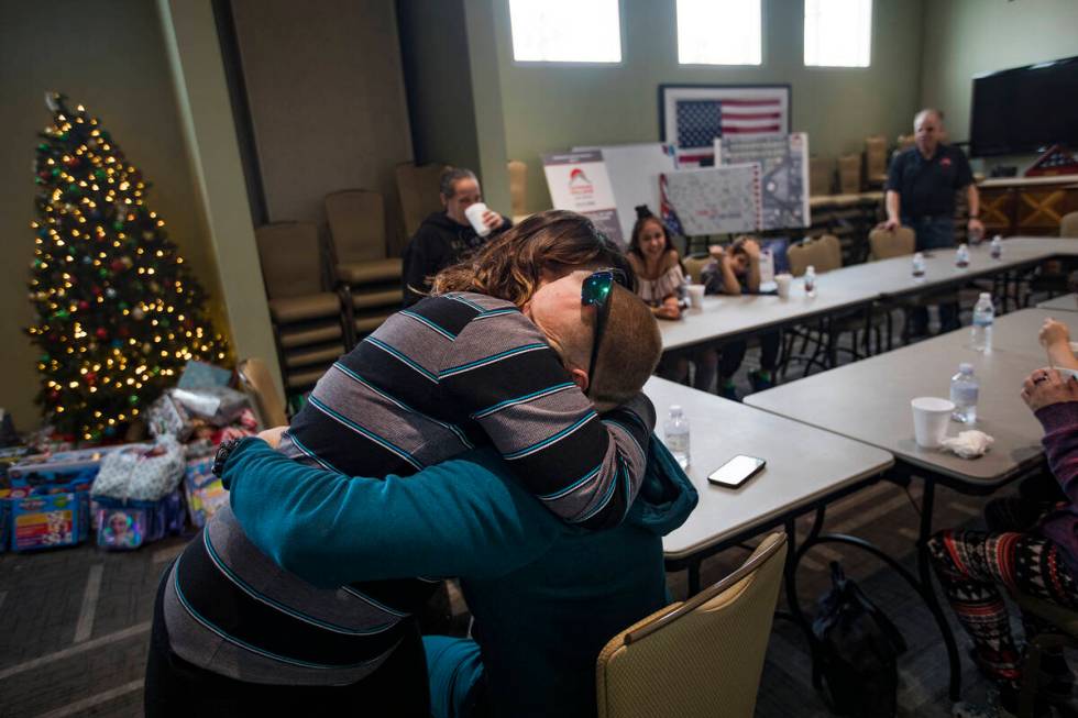 Michelle Aikens hugs her husband Richard Aikens, both survivors of the Alpine Motel fire, at SH ...